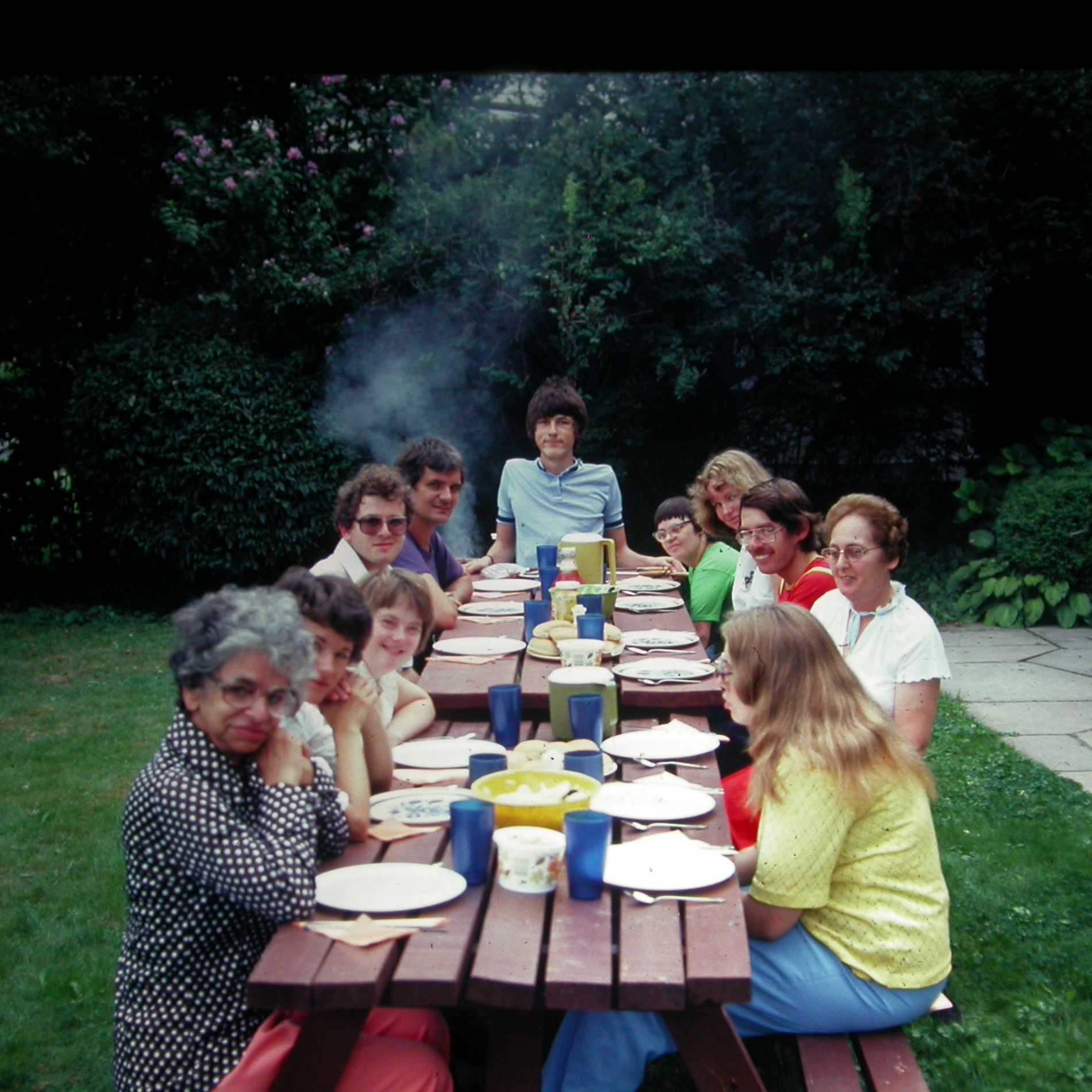 A group picnic dinner at the first Karis group home in Kitchener, Ontario, including staff and people supported.