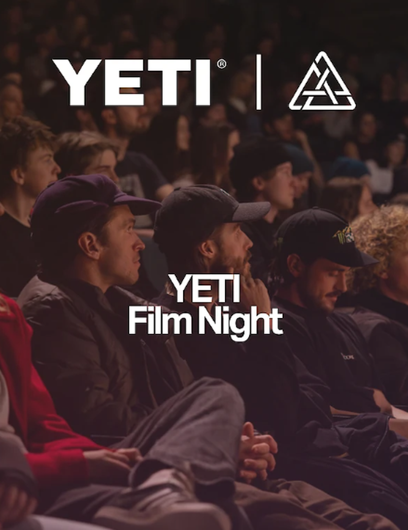 Audience seated in a dimly lit theater during YETI Film Night, with YETI logo prominently displayed above.