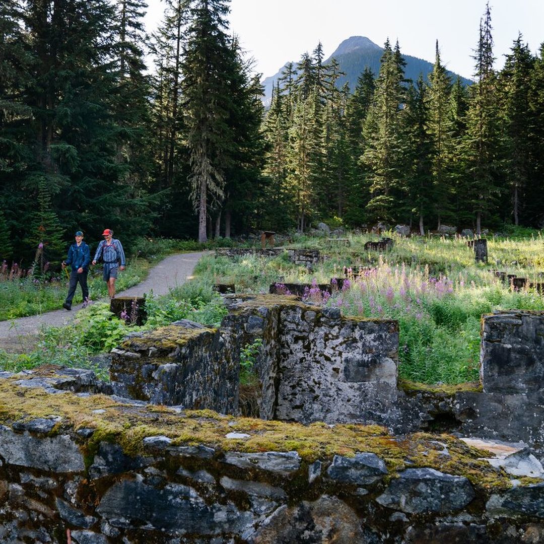 couple walking beside ruined buildings