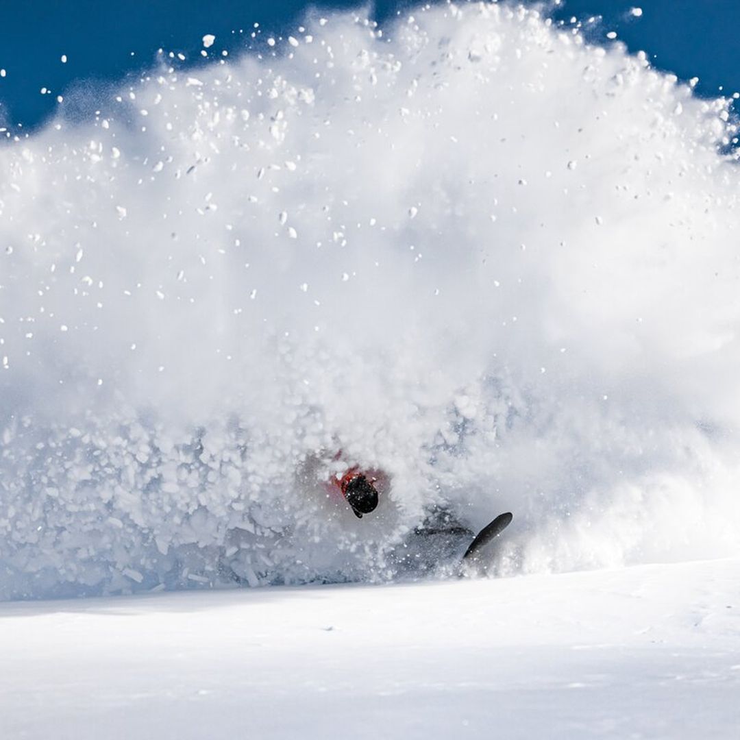 snowboarder slashing pow