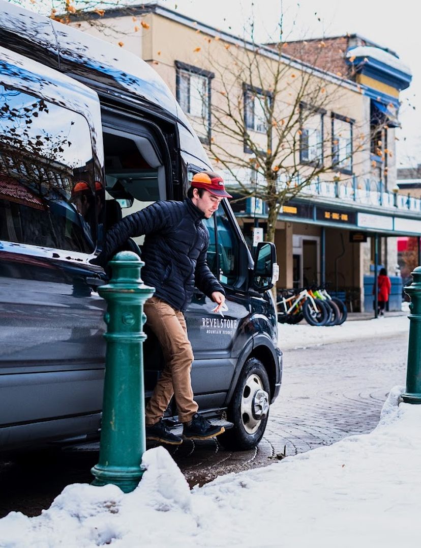male getting out of private transportation van in downtown revelstoke