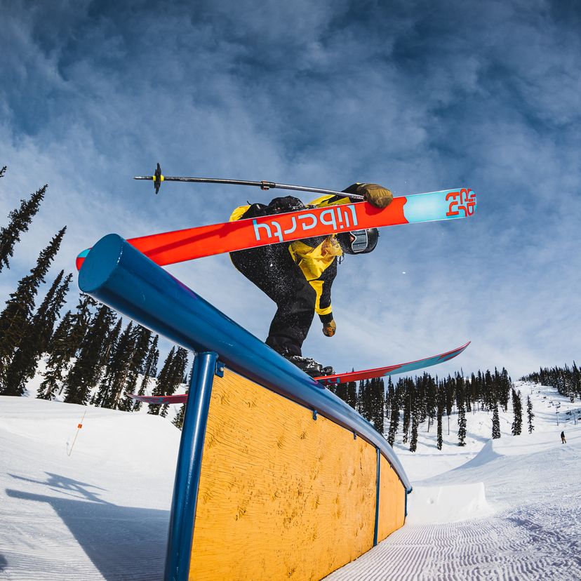 skier on ramp in terrain park doing trick