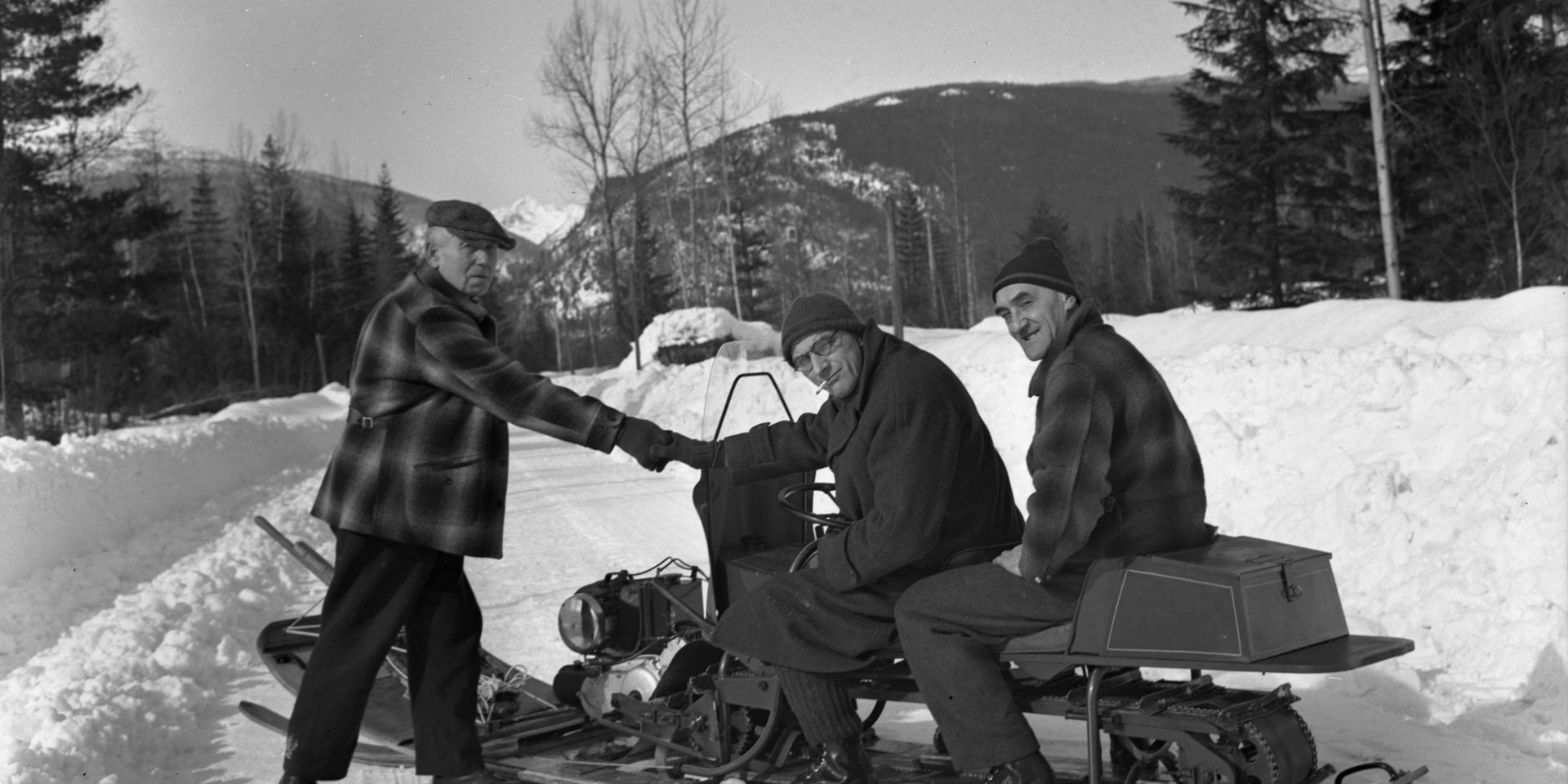 three guys with snowmobile