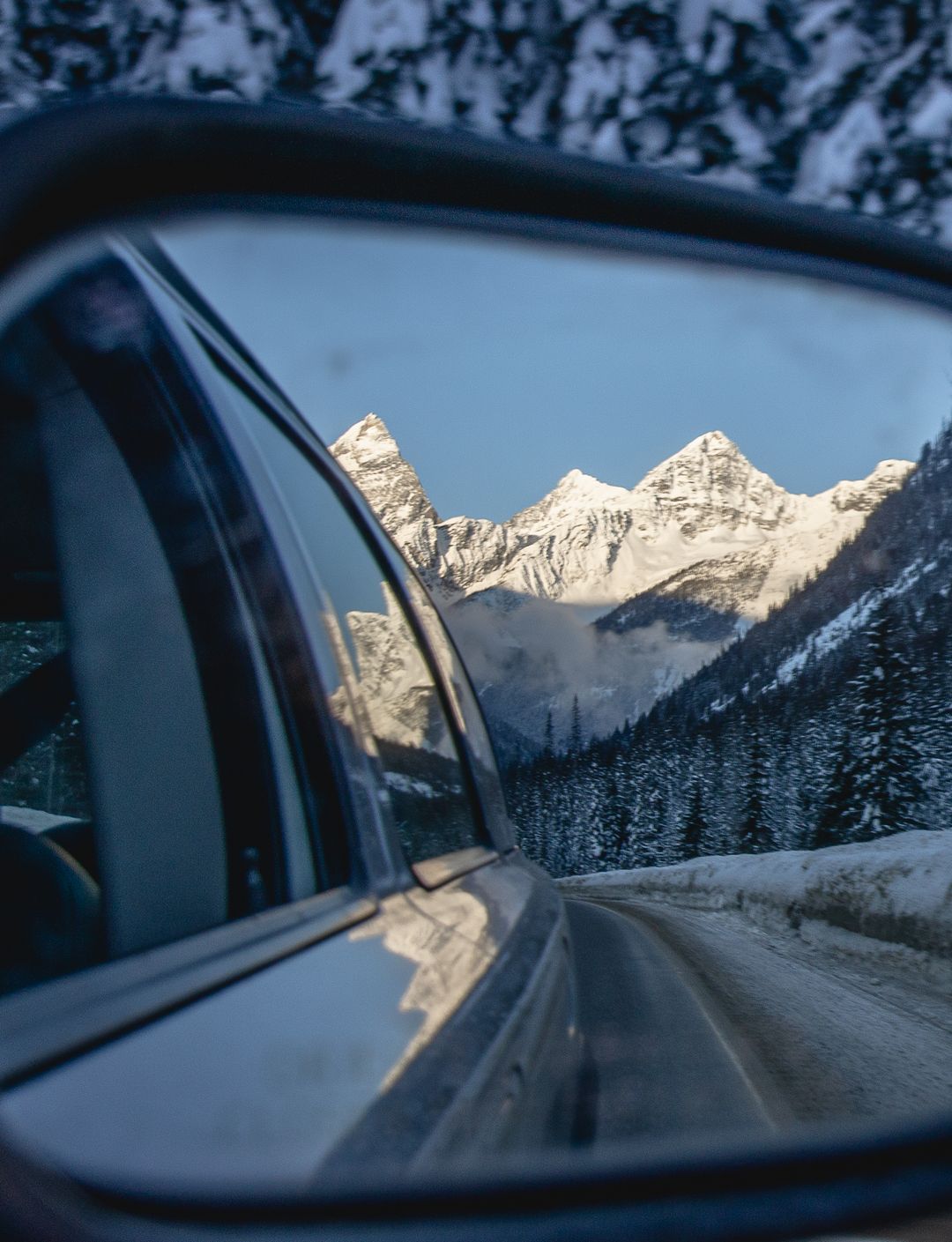 mountains through rear view mirror