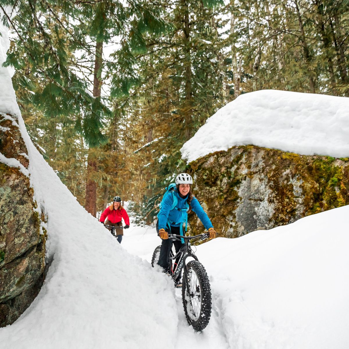 male and female fat biking in forest trail