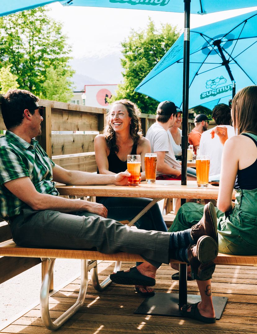 Rumpus patio with picnic benches and umbrellas