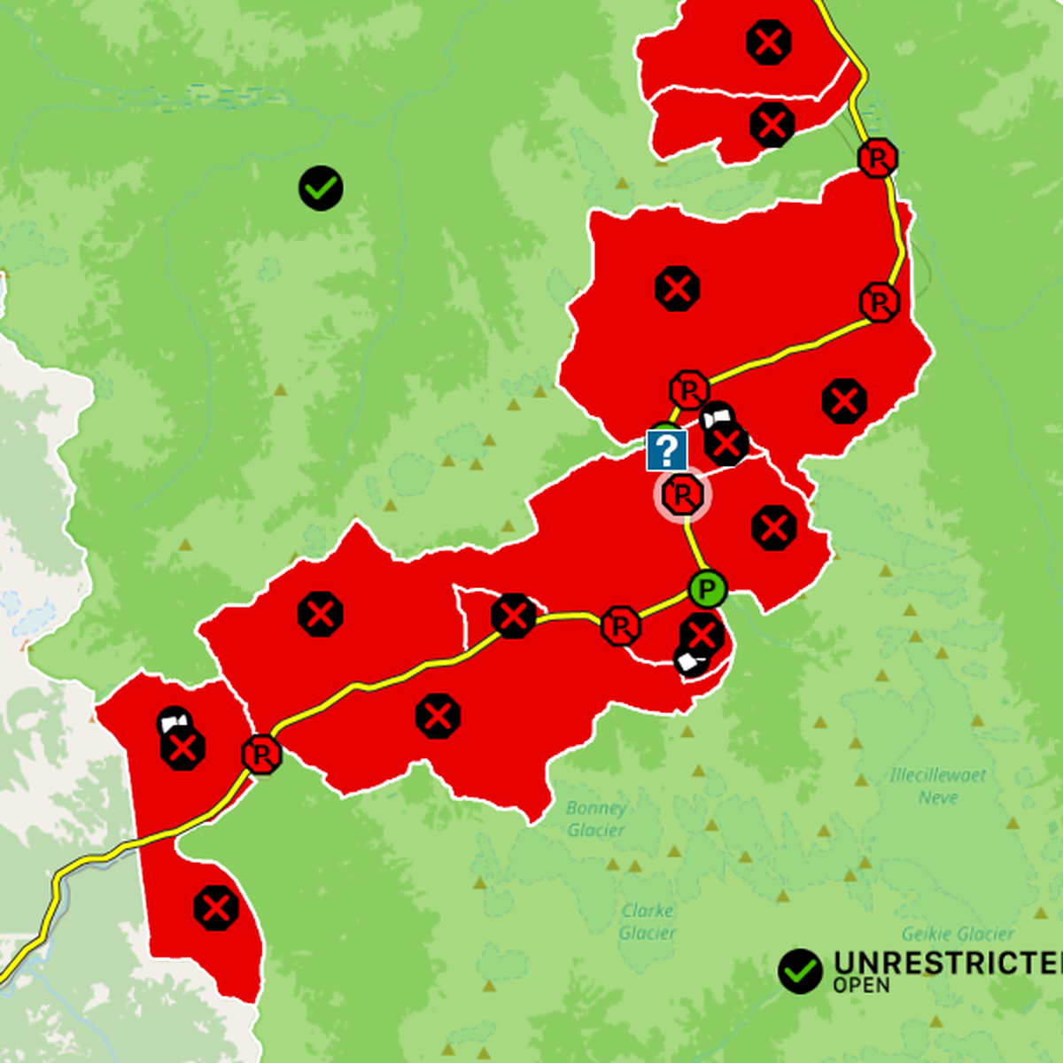 Map showing red restricted areas with black "R" symbols, green unrestricted area, yellow route, and a question mark icon near the center.