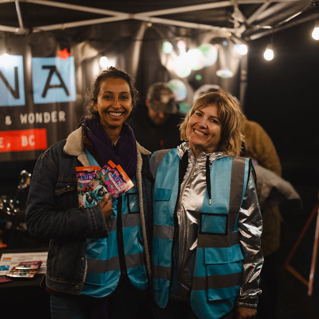 two volunteers working at a booth