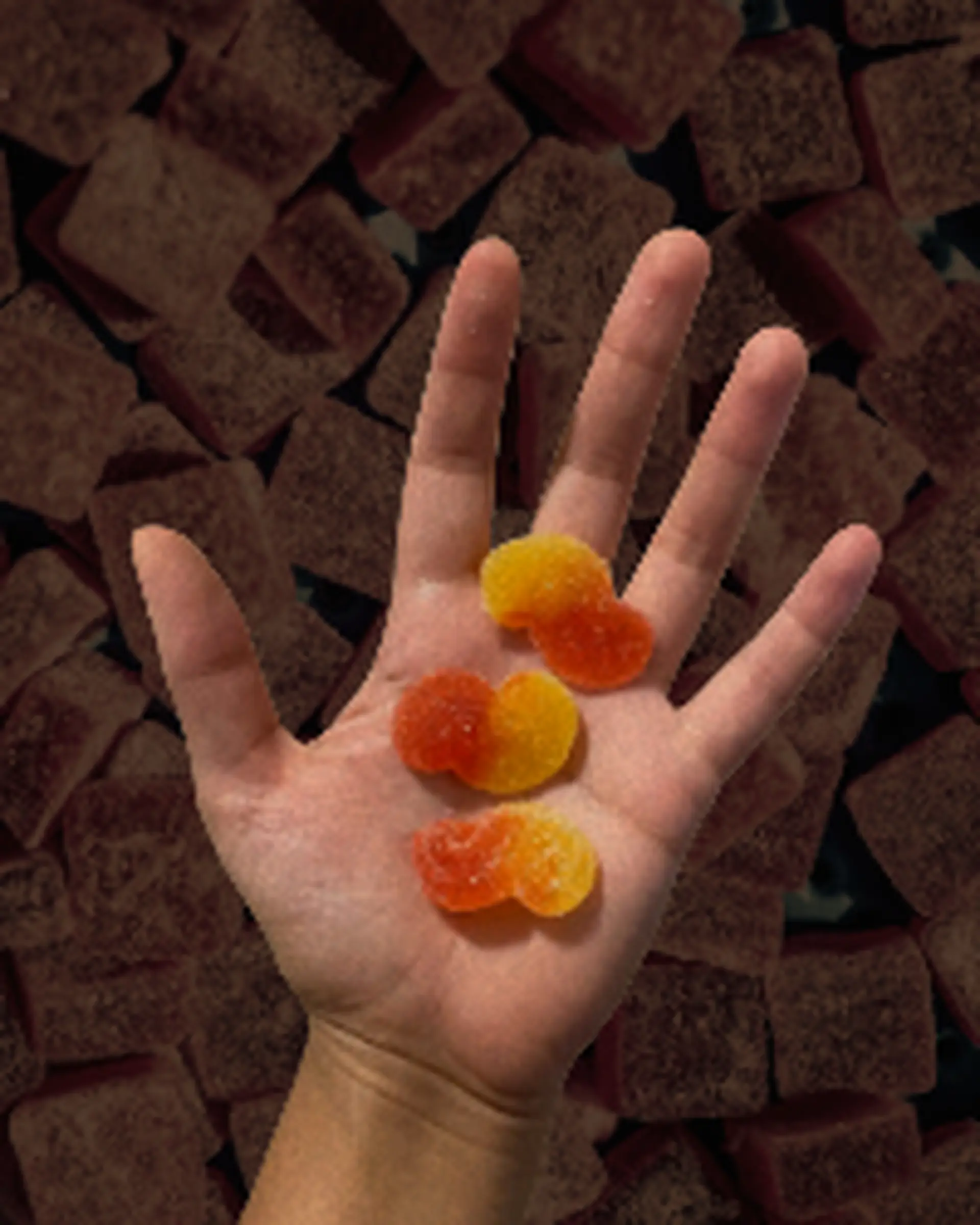 hand holding thc cbd edible gummies for kindling cannabis 1 hour delivery