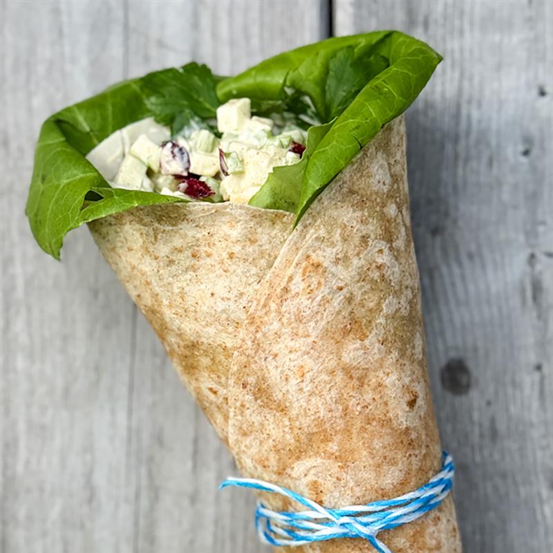 Wrap à la dinde et salade au cari en cornet sur planche de bois