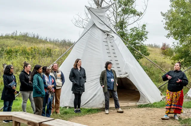 Team members and coaches participating in the Improving Equity in Access to Palliative Care collaborative participating in a guided walk facilitated by Wanuskewin staff.